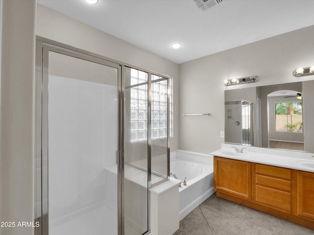 bathroom with tile patterned floors, ceiling fan, vanity, and shower with separate bathtub