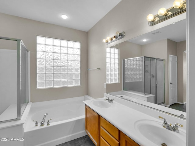 bathroom with tile patterned floors, vanity, and plus walk in shower