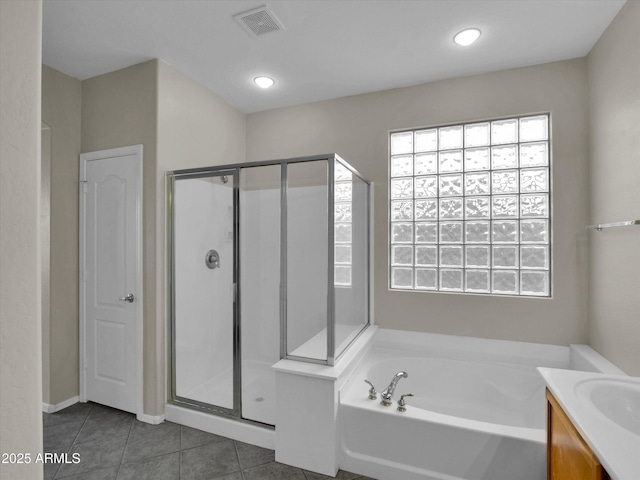 bathroom with tile patterned floors, vanity, and separate shower and tub