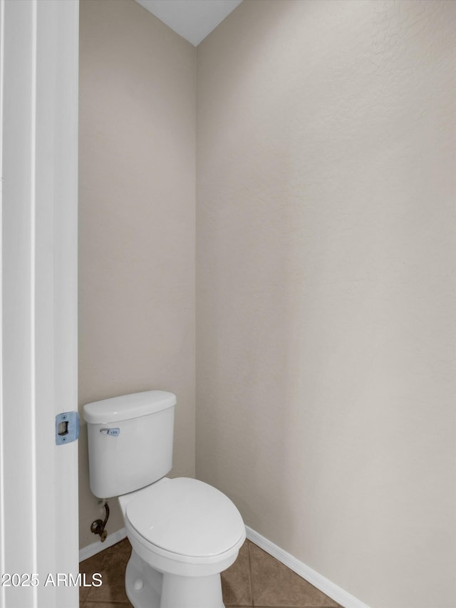 bathroom featuring tile patterned flooring and toilet