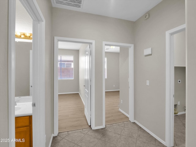 corridor featuring light tile patterned floors