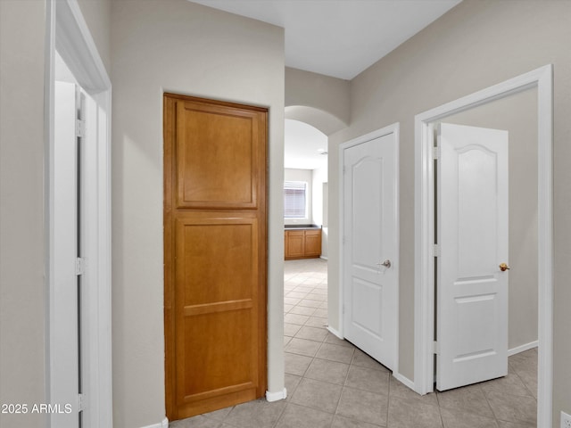 corridor with light tile patterned floors