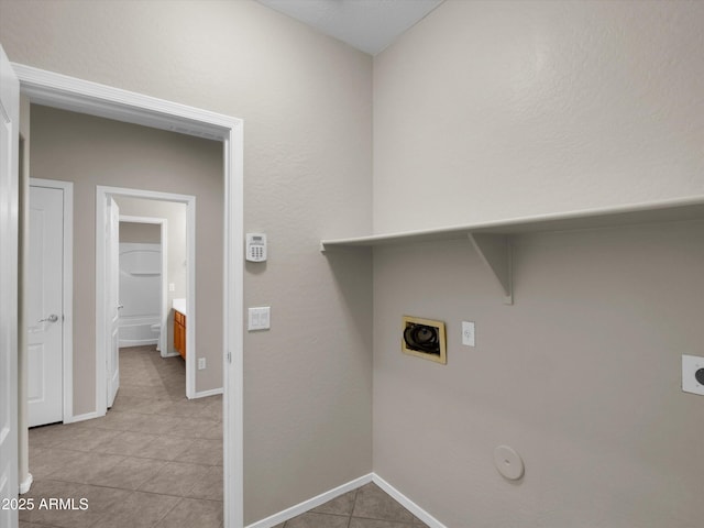 clothes washing area with electric dryer hookup, light tile patterned flooring, and gas dryer hookup