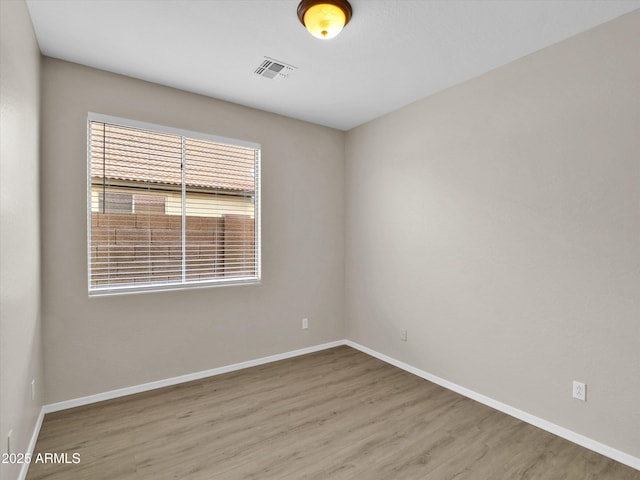 spare room featuring hardwood / wood-style flooring