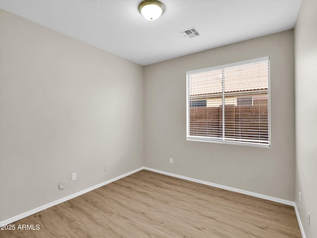 spare room featuring light hardwood / wood-style flooring