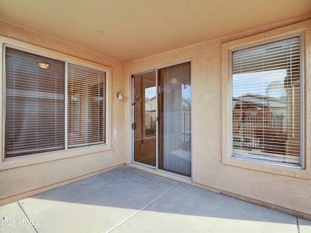 entrance to property with a patio