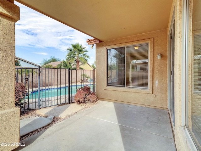 view of patio / terrace with a fenced in pool