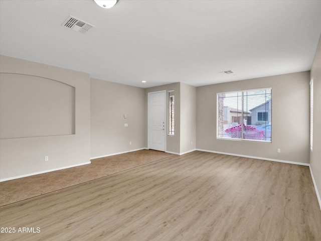 unfurnished room with light hardwood / wood-style flooring