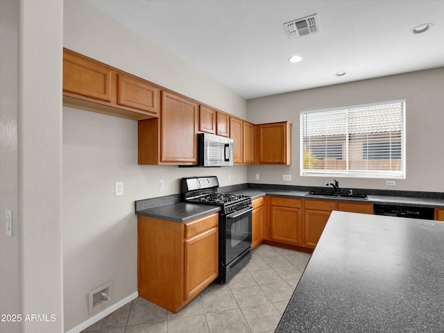 kitchen with black appliances, light tile patterned floors, and sink