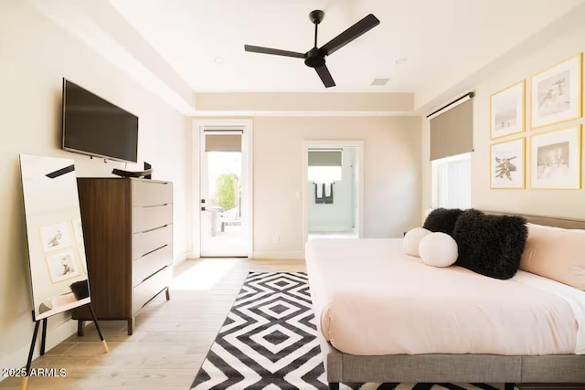 bedroom featuring ceiling fan, light hardwood / wood-style flooring, and access to outside