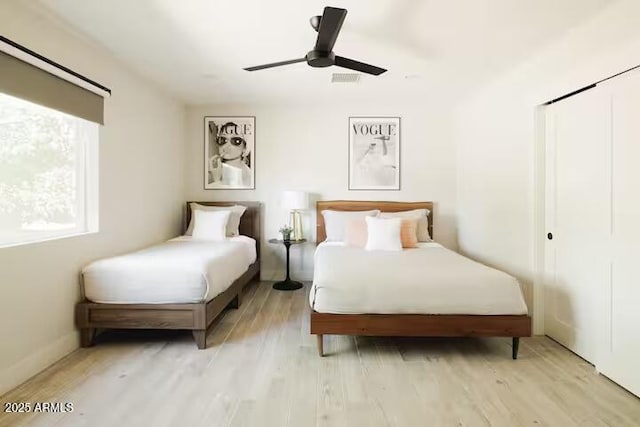 bedroom with ceiling fan and light hardwood / wood-style flooring