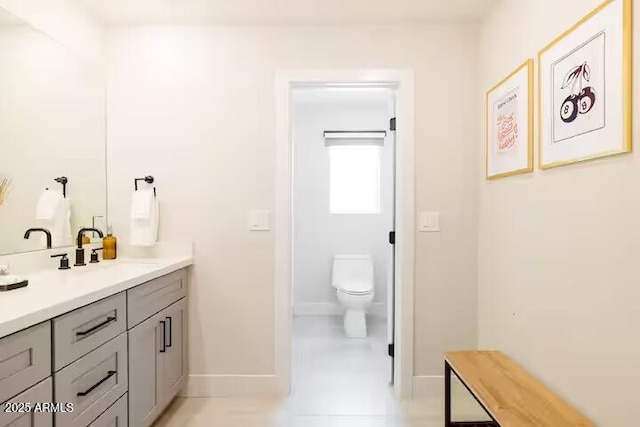 bathroom featuring toilet and vanity