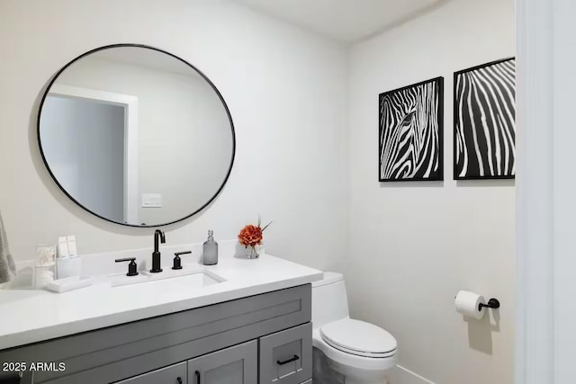 bathroom featuring toilet and vanity