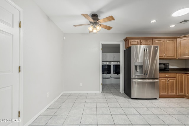 1240 E Indigo St, Mesa, AZ 85203 - kitchen with visible vents, dark countertops, stainless steel fridge, a ceiling fan, and independent washer and dryer
