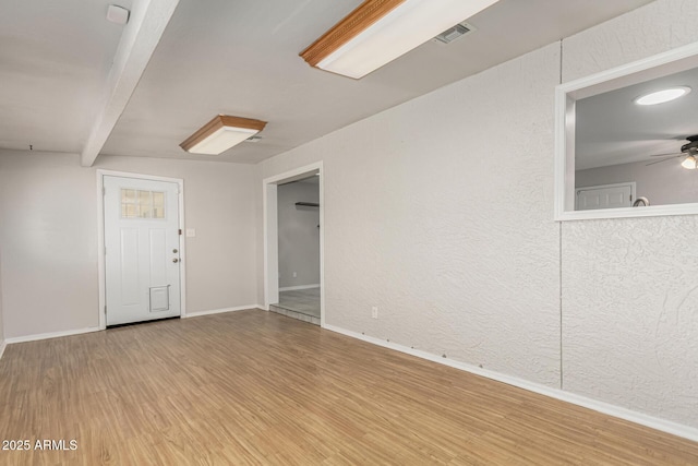 1240 E Indigo St, Mesa, AZ 85203 - unfurnished room with baseboards, a ceiling fan, light wood-style flooring, and visible vents