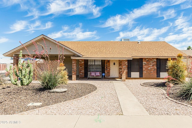 1240 E Indigo St, Mesa, AZ 85203 - single story home featuring a porch, a shingled roof, and brick siding