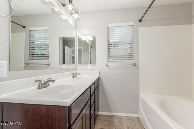 bathroom featuring shower / bathing tub combination, double vanity, tile patterned floors, and a sink