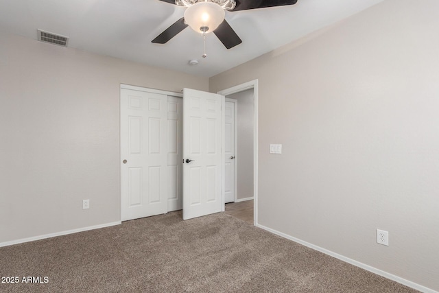 unfurnished bedroom with baseboards, visible vents, carpet, a closet, and ceiling fan