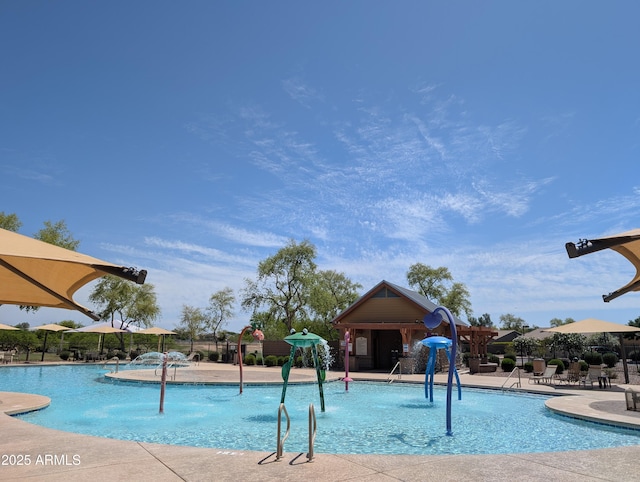 community pool featuring a patio and fence