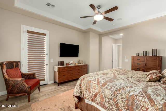 bedroom featuring a ceiling fan, light wood-type flooring, visible vents, and baseboards