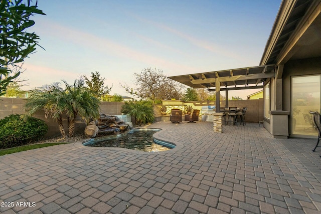 patio terrace at dusk featuring outdoor dining space, a fenced backyard, a fenced in pool, and a pergola