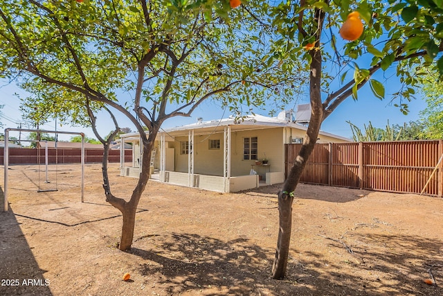 rear view of house featuring a patio and a fenced backyard