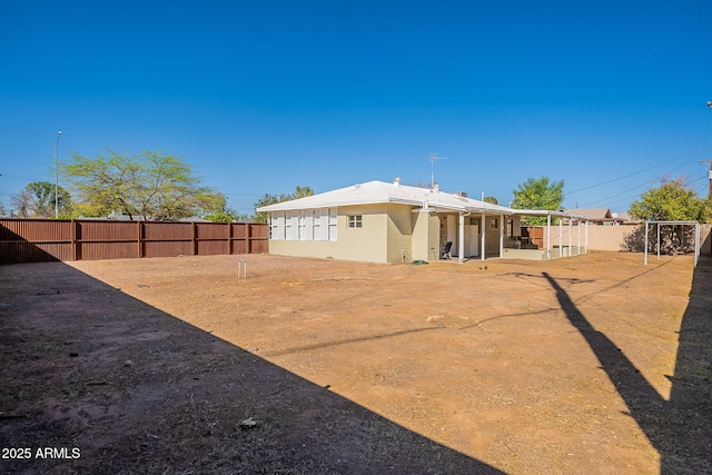 rear view of house featuring fence