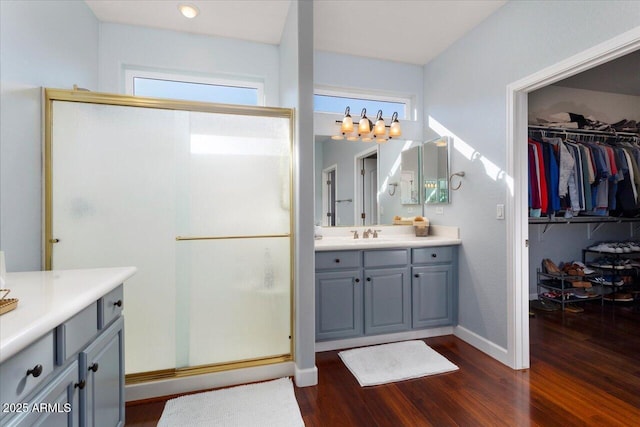 bathroom with vanity, hardwood / wood-style floors, and walk in shower