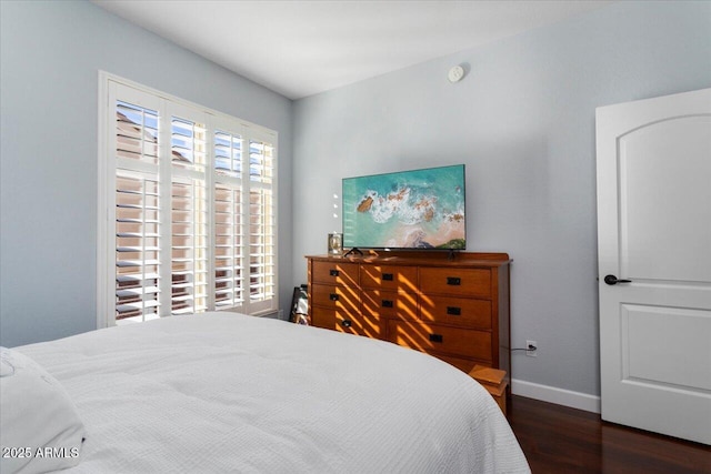 bedroom with dark hardwood / wood-style floors