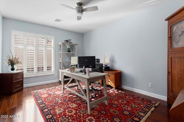 home office with ceiling fan and dark wood-type flooring