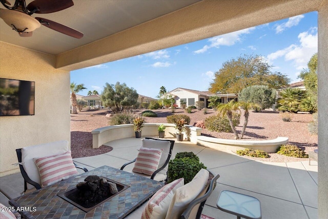 view of patio / terrace featuring ceiling fan and an outdoor fire pit