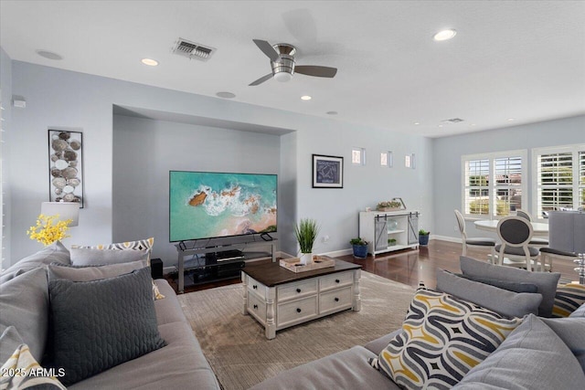 living room featuring ceiling fan and wood-type flooring