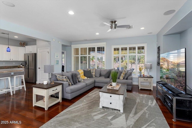 living room with ceiling fan and dark hardwood / wood-style floors