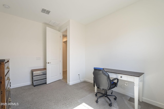 carpeted office space featuring visible vents and baseboards