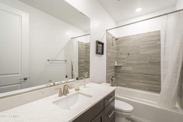 bathroom featuring toilet, shower / tub combo with curtain, and vanity