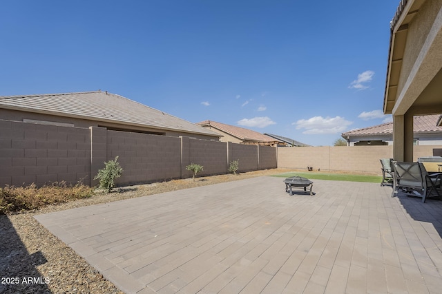 view of patio / terrace with a fenced backyard and a fire pit