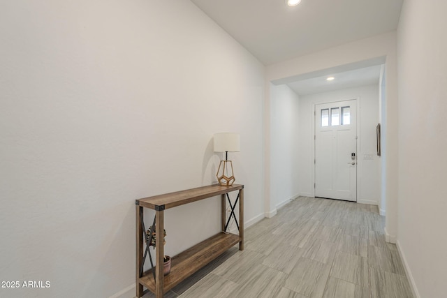 entryway with baseboards and recessed lighting