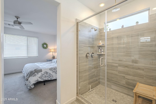 bathroom with a wealth of natural light, ceiling fan, a shower stall, and ensuite bathroom