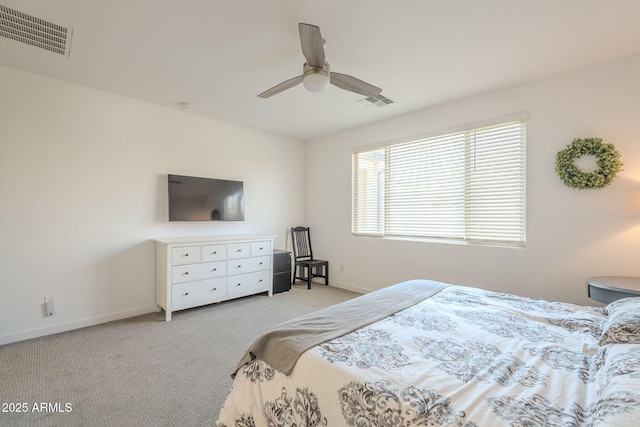 bedroom featuring baseboards, visible vents, and light colored carpet