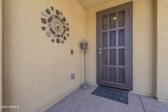 property entrance featuring stucco siding