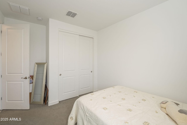 carpeted bedroom with a closet and visible vents