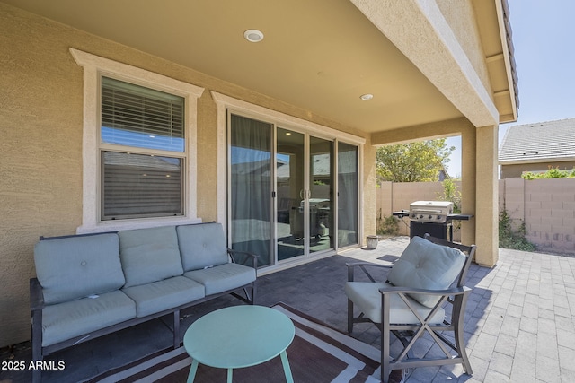 view of patio / terrace with a grill, fence, and an outdoor hangout area