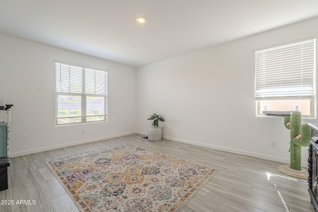 living area featuring baseboards and wood finished floors