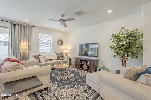 living room featuring ceiling fan, visible vents, and recessed lighting