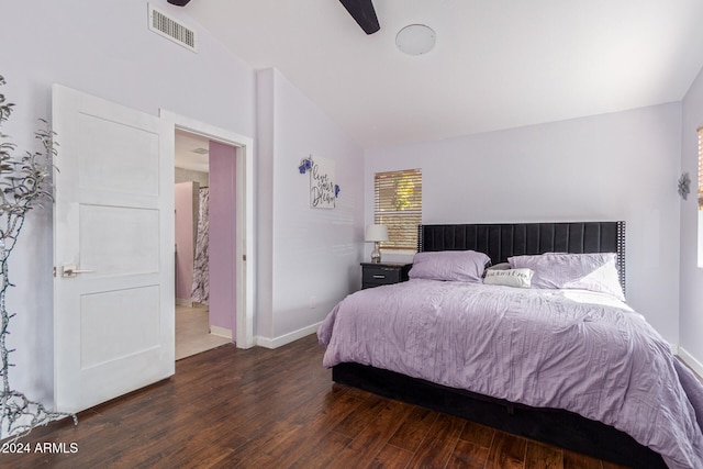 bedroom featuring ceiling fan, dark wood-type flooring, and vaulted ceiling