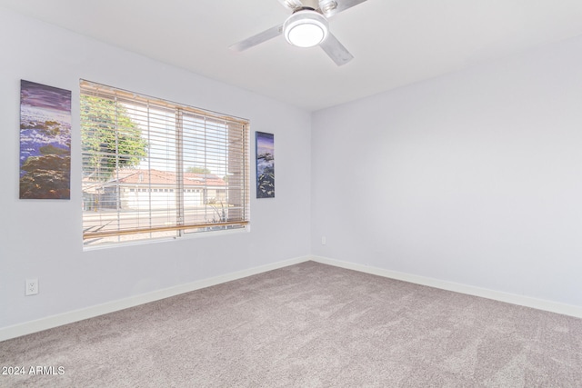 carpeted empty room featuring ceiling fan