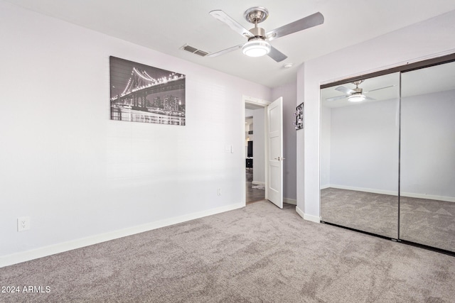 unfurnished bedroom with carpet flooring, ceiling fan, and a closet