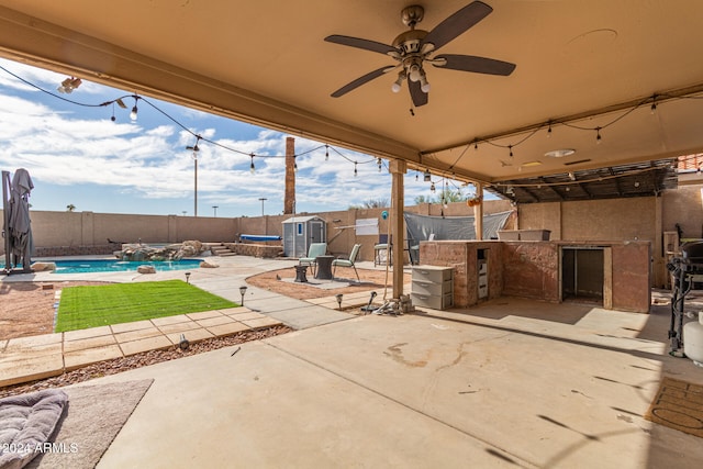 view of patio / terrace with a fenced in pool, area for grilling, and ceiling fan