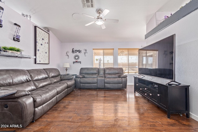 living room featuring ceiling fan and dark hardwood / wood-style floors