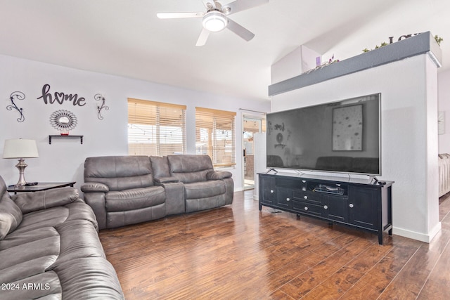 living room featuring dark hardwood / wood-style floors, ceiling fan, radiator, and vaulted ceiling